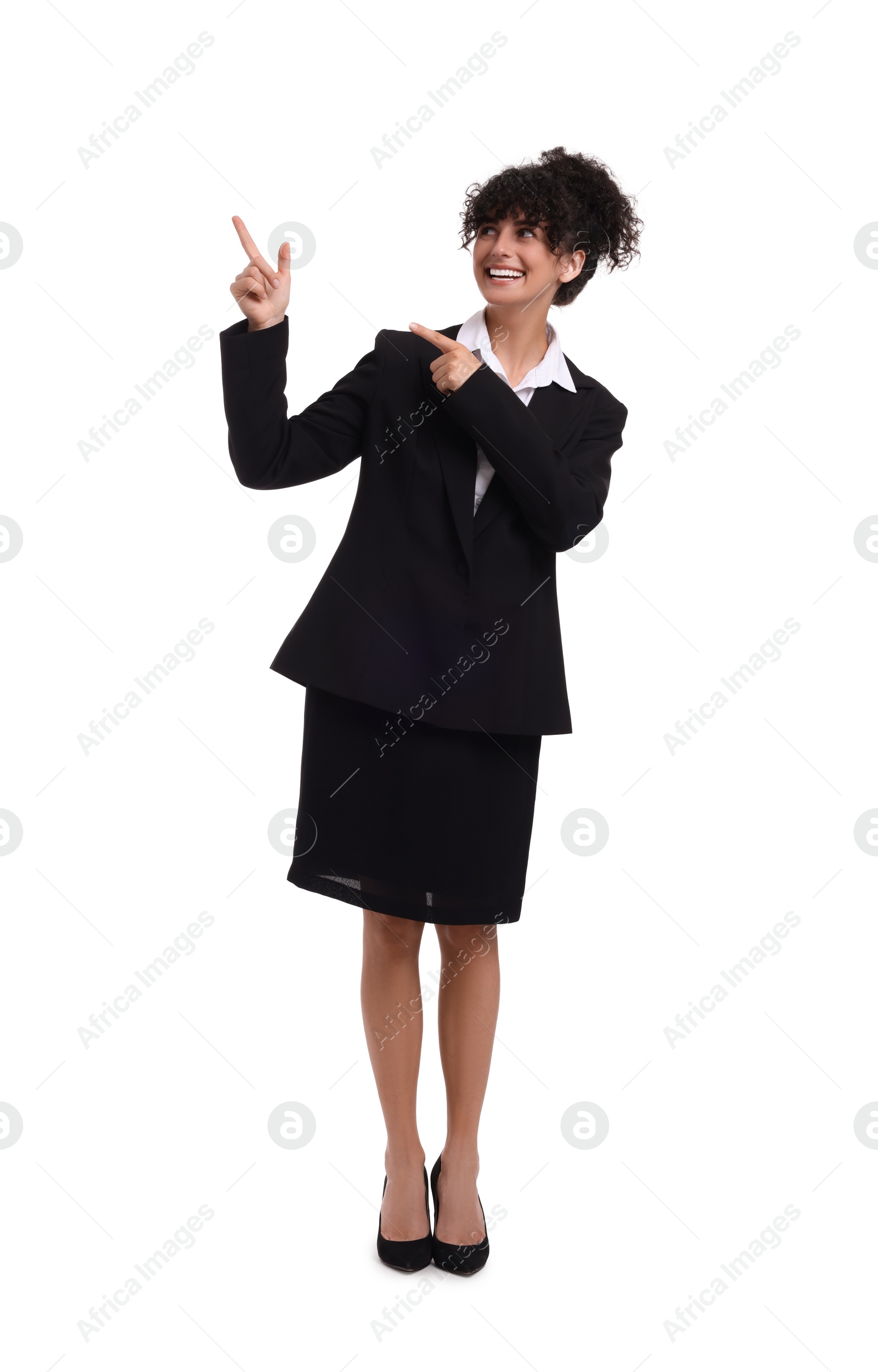 Photo of Beautiful happy businesswoman pointing at something on white background