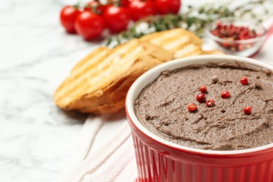 Photo of Tasty liver pate with pepper in bowl on table, closeup. Space for text