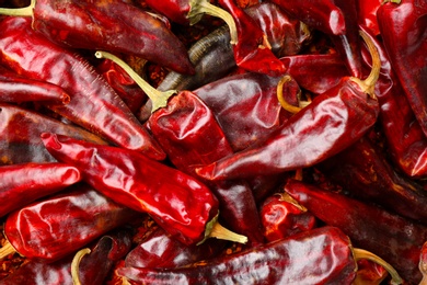 Photo of Dry chili peppers as background, closeup