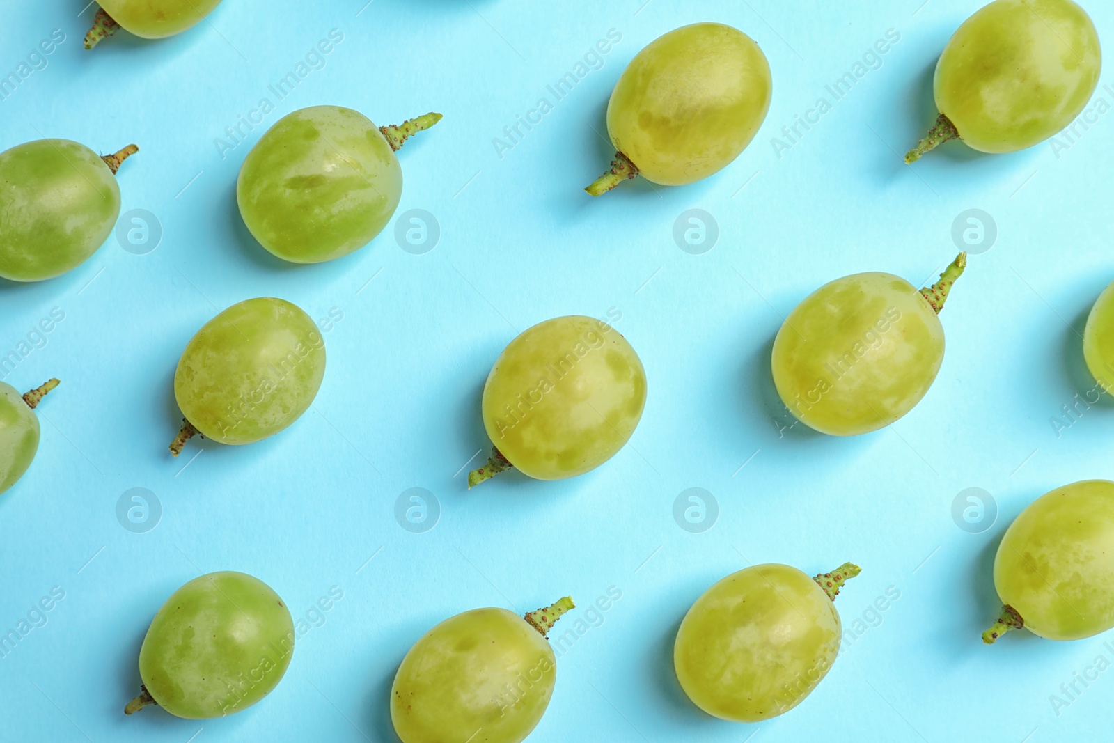 Photo of Fresh ripe juicy green grapes on color background, top view