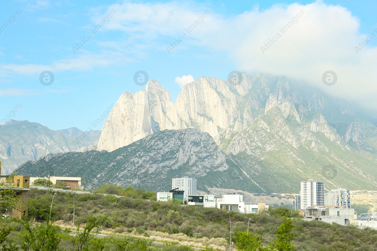 Photo of Town near beautiful mountain landscape under blue sky