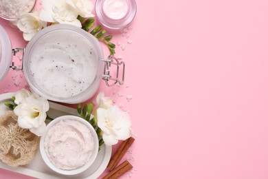 Photo of Flat lay composition with body scrubs on pink background, space for text