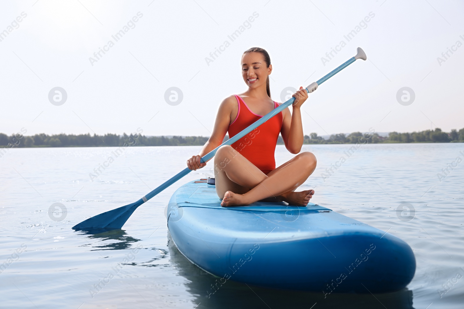 Photo of Woman paddle boarding on SUP board in sea