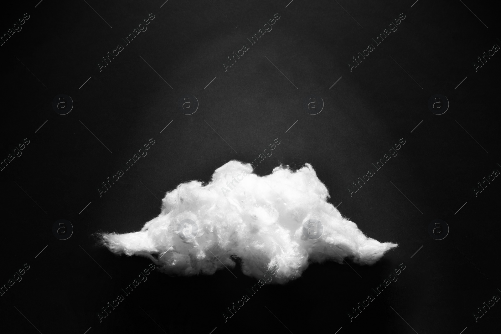 Photo of Cloud made of cotton on black background. Space for text