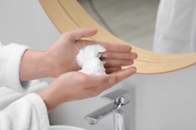 Photo of Man holding shaving foam in bathroom, closeup