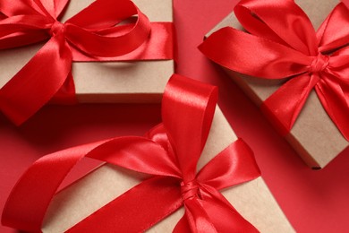 Photo of Beautiful gift boxes on red background, closeup