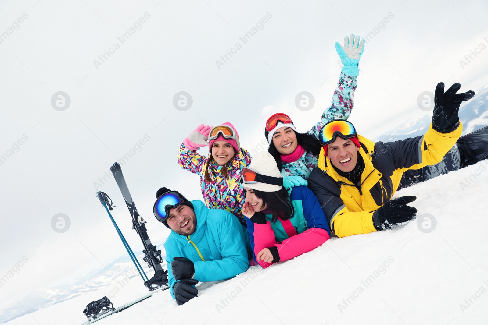 Photo of Group of friends with equipment in snowy mountains. Winter vacation