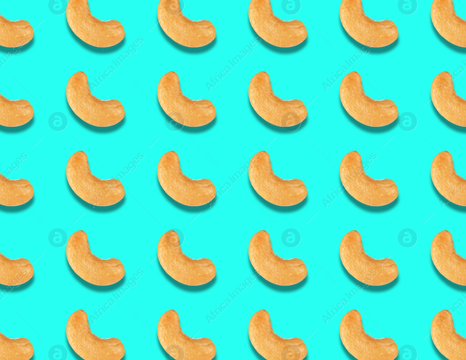 Image of Many tasty cashew nuts on turquoise background, flat lay