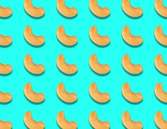 Image of Many tasty cashew nuts on turquoise background, flat lay