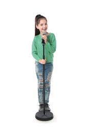 Photo of Little girl singing into microphone on white background