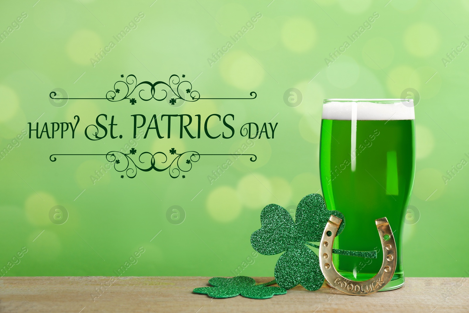 Image of Green beer, horseshoe and clover leaves on wooden table. St. Patrick's Day celebration