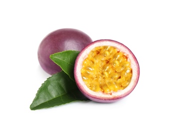 Half of delicious passion fruit (maracuya) and green leaves on white background