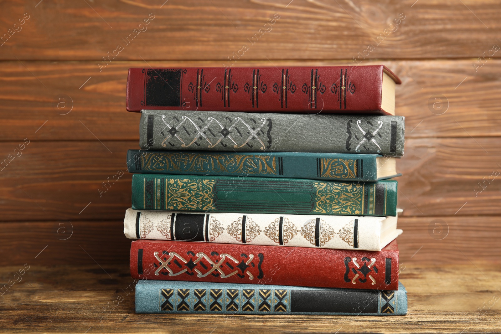 Photo of Collection of old books on wooden shelf