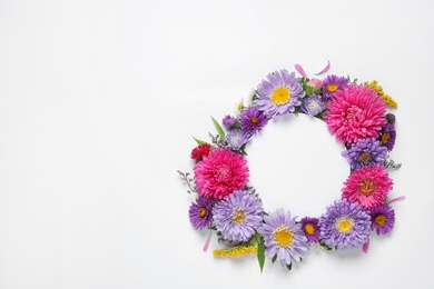 Composition with beautiful aster flowers and blank card on white background, top view. Space for text