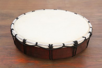 Modern drum on wooden table, closeup. Percussion musical instrument