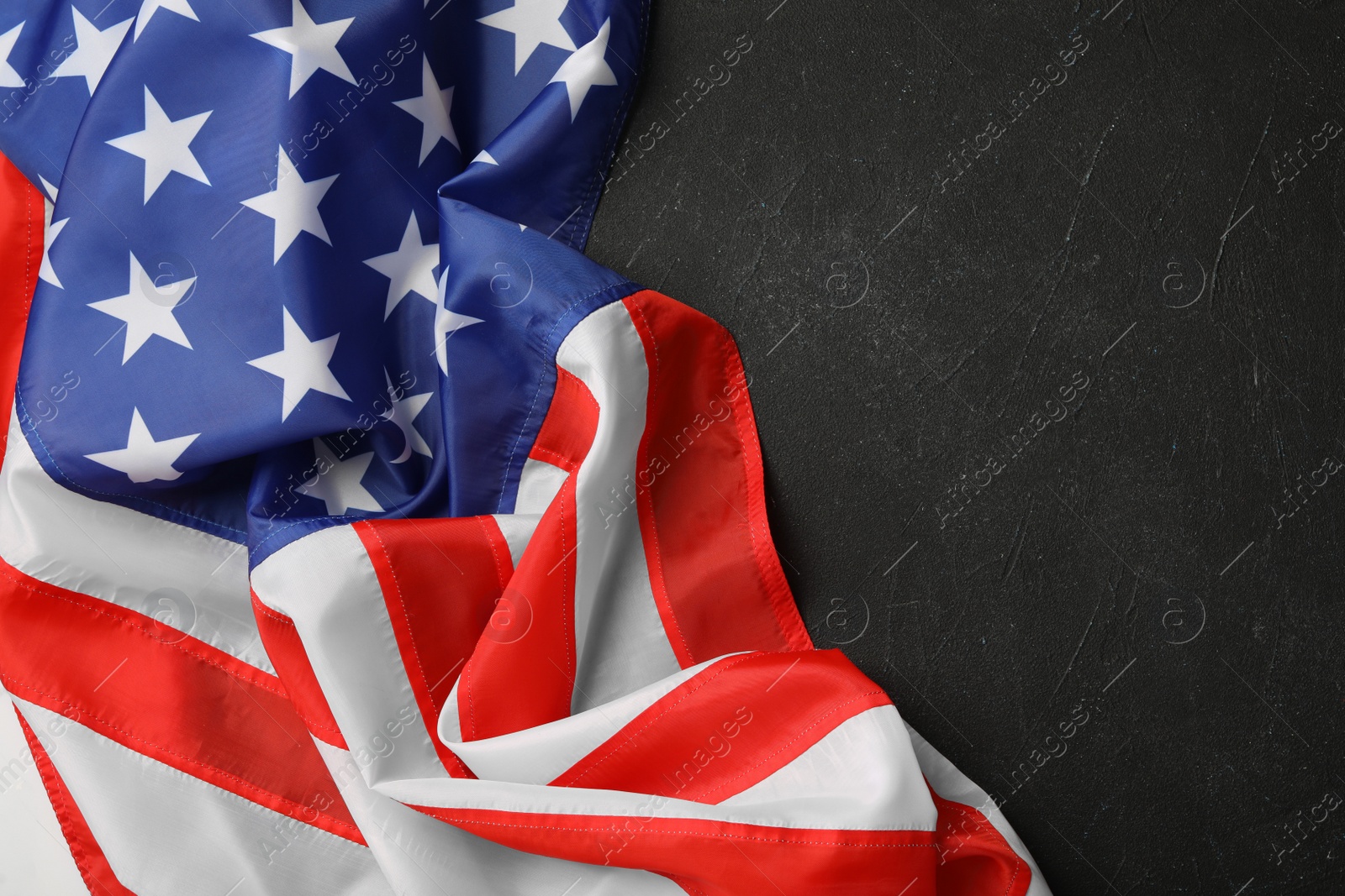 Photo of American flag on black table, top view with space for text. Memorial Day