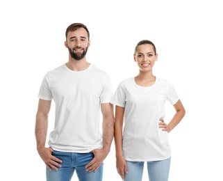 Photo of Young couple in t-shirts on white background. Mockup for design