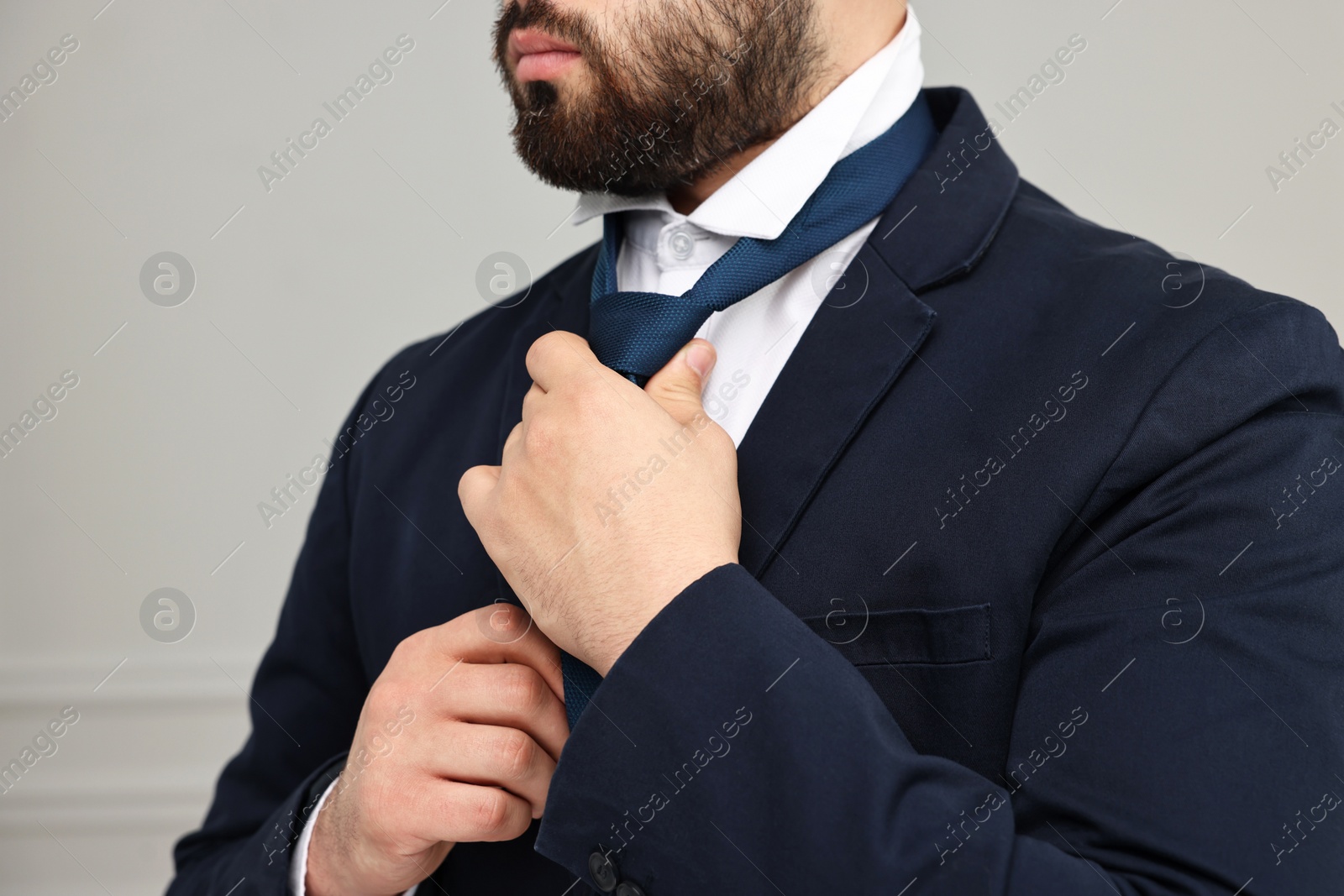 Photo of Businessman in suit and necktie indoors, closeup