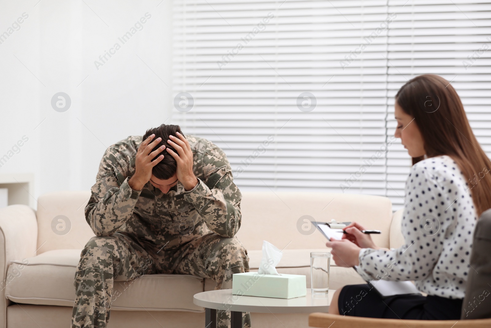 Photo of Psychotherapist working with male military officer in office