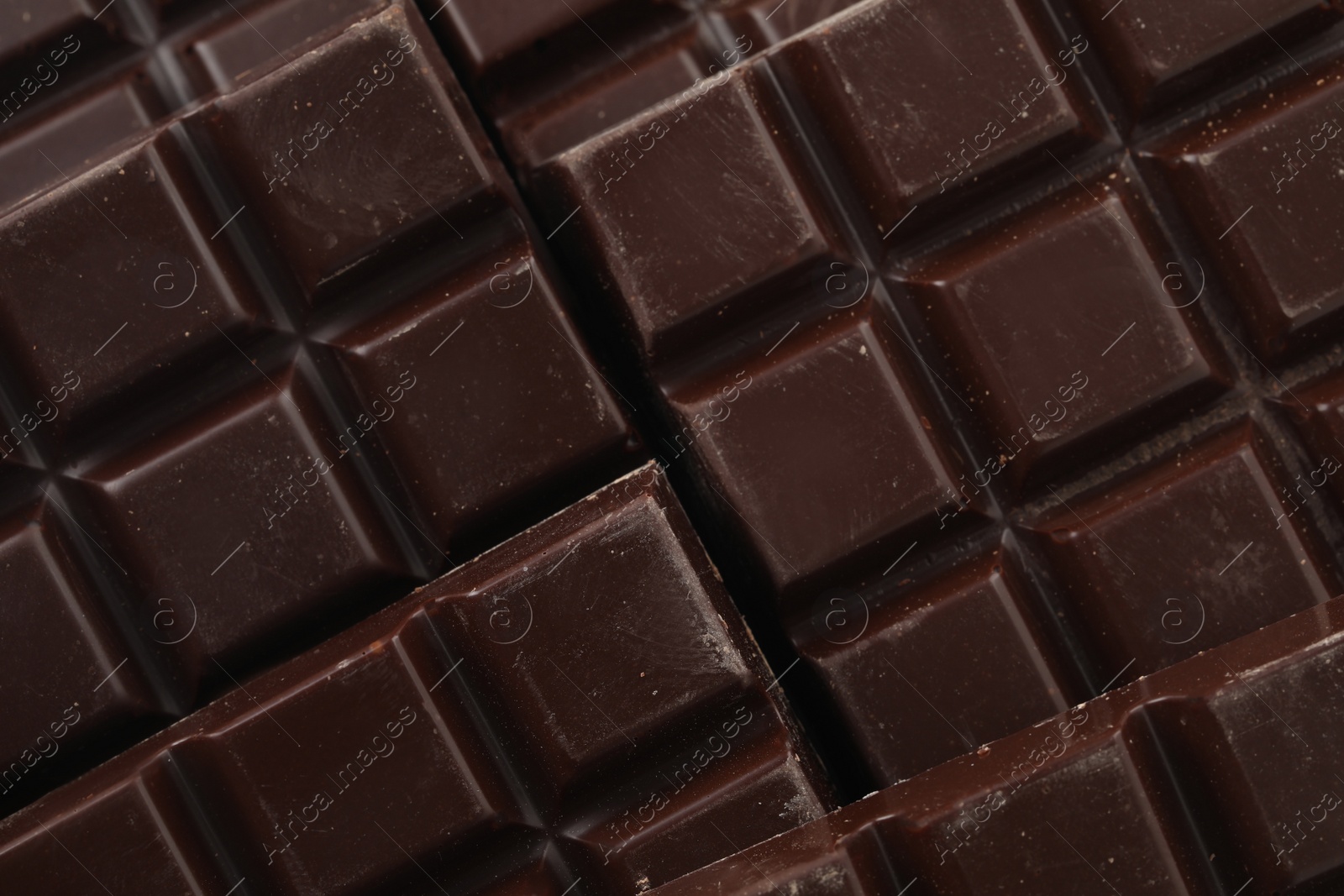 Photo of Delicious dark chocolate as background, closeup view