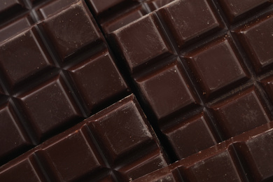 Photo of Delicious dark chocolate as background, closeup view