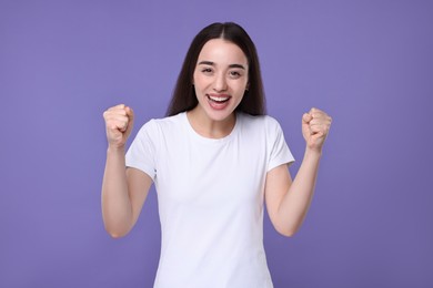 Photo of Portrait of happy surprised woman on violet background