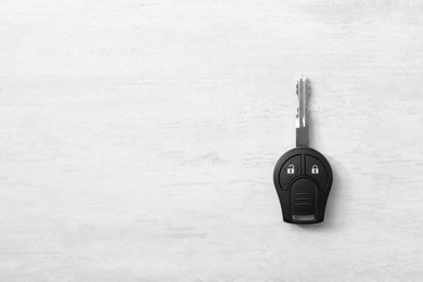 Car key on light background, top view. Space for text