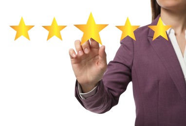 Quality evaluation. Businesswoman touching virtual golden star on white background, closeup