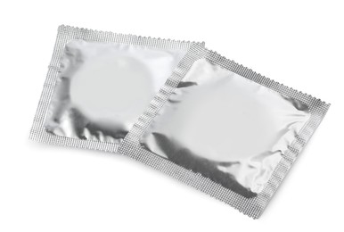 Photo of Condom packages isolated on white. Safe sex