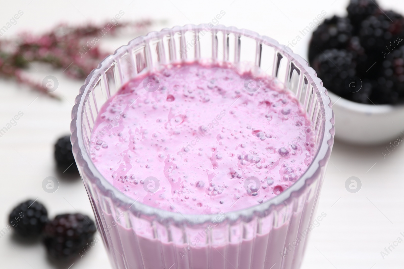Photo of Delicious fresh blackberry smoothie in glass, closeup