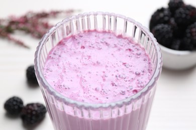 Photo of Delicious fresh blackberry smoothie in glass, closeup
