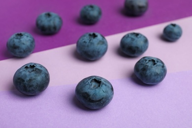 Photo of Tasty blueberry on color background, closeup