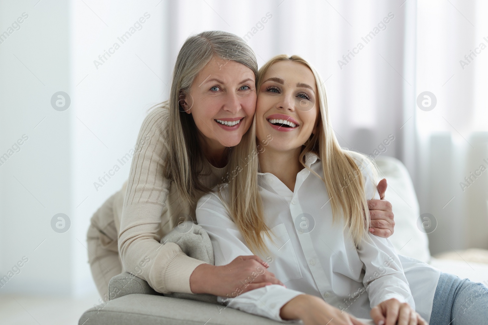 Photo of Family portrait of young woman and her mother at home