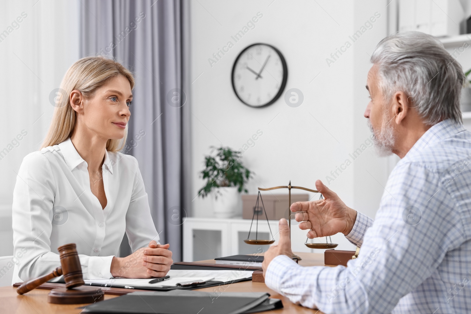 Photo of Senior man having meeting with lawyer in office