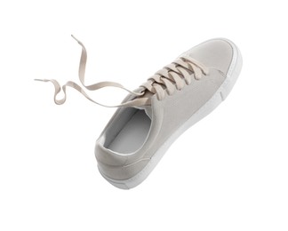 Photo of One stylish beige sneaker isolated on white