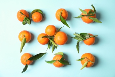 Photo of Flat lay composition with ripe tangerines on color background