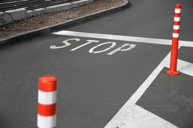 White painted stop marking on asphalt outdoors