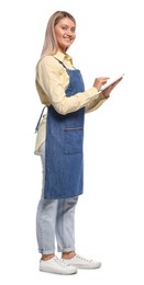 Photo of Beautiful young woman in denim apron with tablet on white background