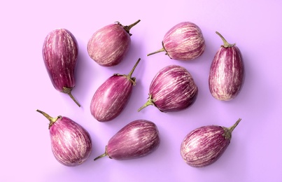 Raw ripe eggplants on light background, flat lay