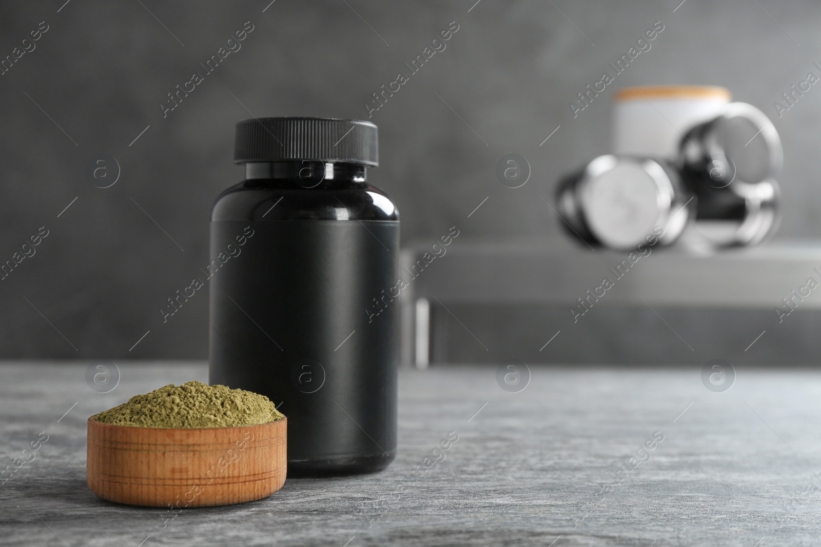Photo of Hemp protein powder in bowl and jar on table. Space for text