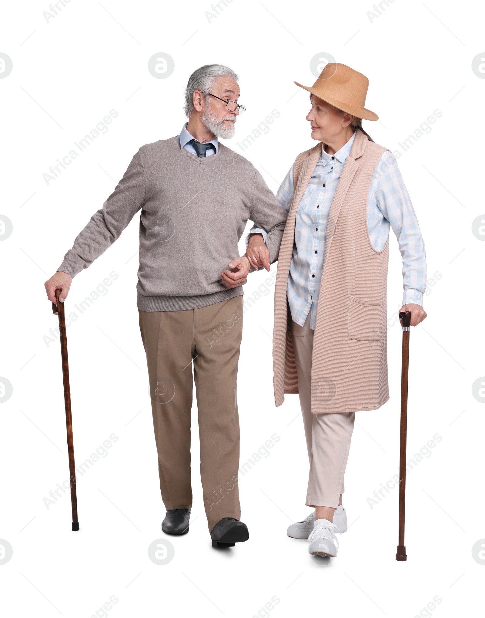 Photo of Senior man and woman with walking canes on white background