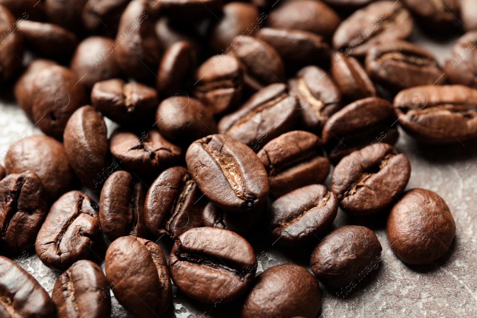 Photo of Roasted coffee beans on grey background, closeup