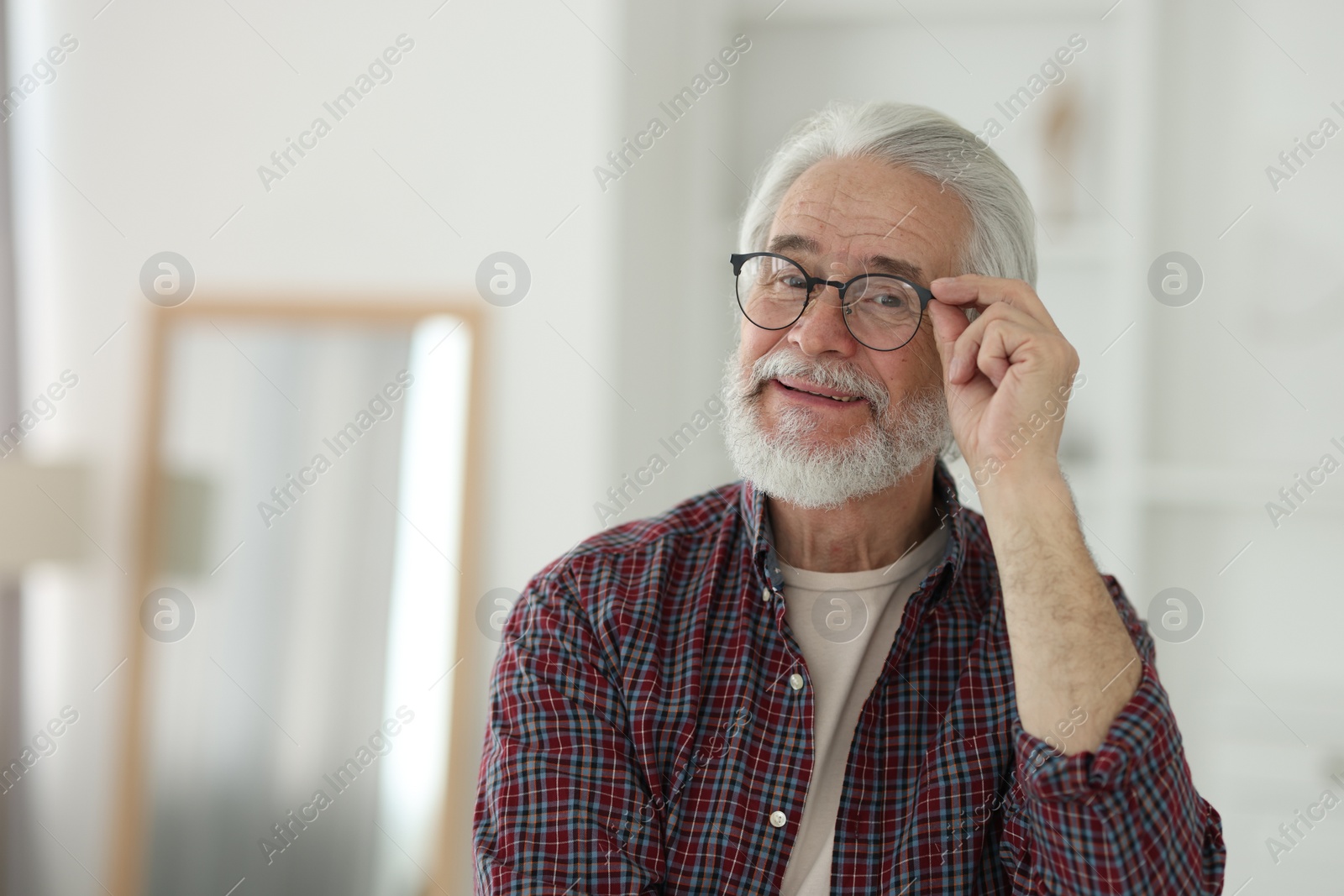 Photo of Portrait of happy grandpa with glasses indoors