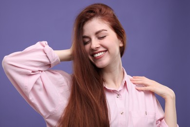 Photo of Portrait of smiling woman with freckles on purple background