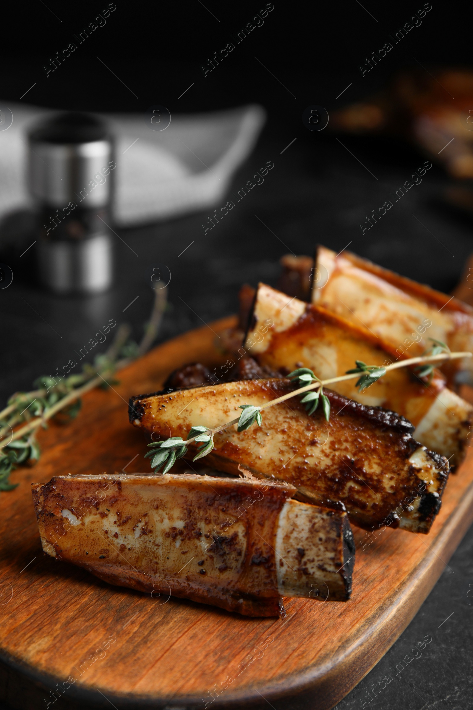 Photo of Delicious roasted ribs served on wooden board