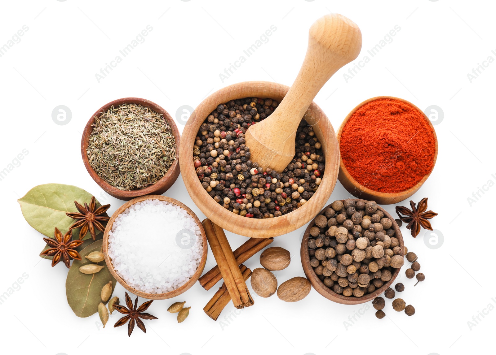 Photo of Mortar with pestle and different spices on white background, top view