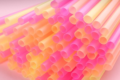 Heap of colorful plastic straws for drinks, closeup