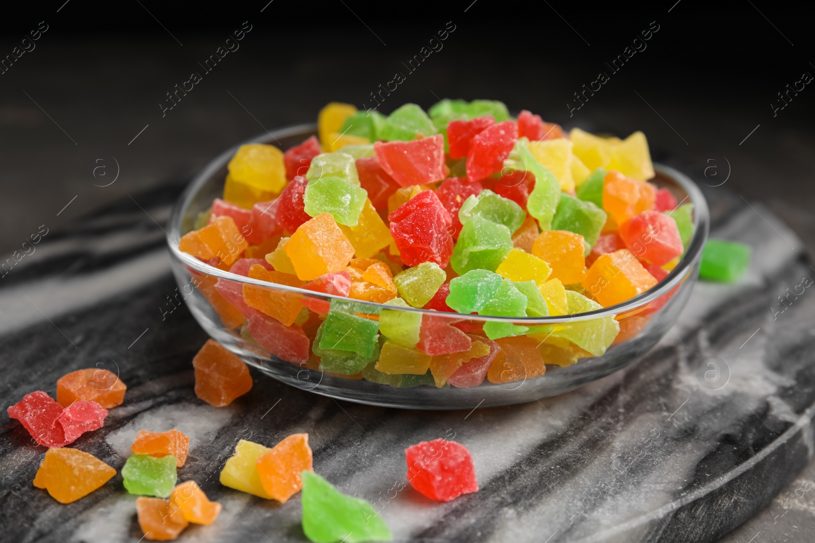 Photo of Mix of delicious candied fruits on marble board, closeup