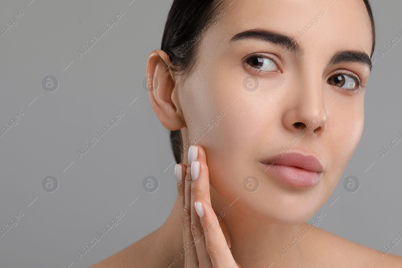 Photo of Young woman with dry skin on gray background, closeup. Space for text