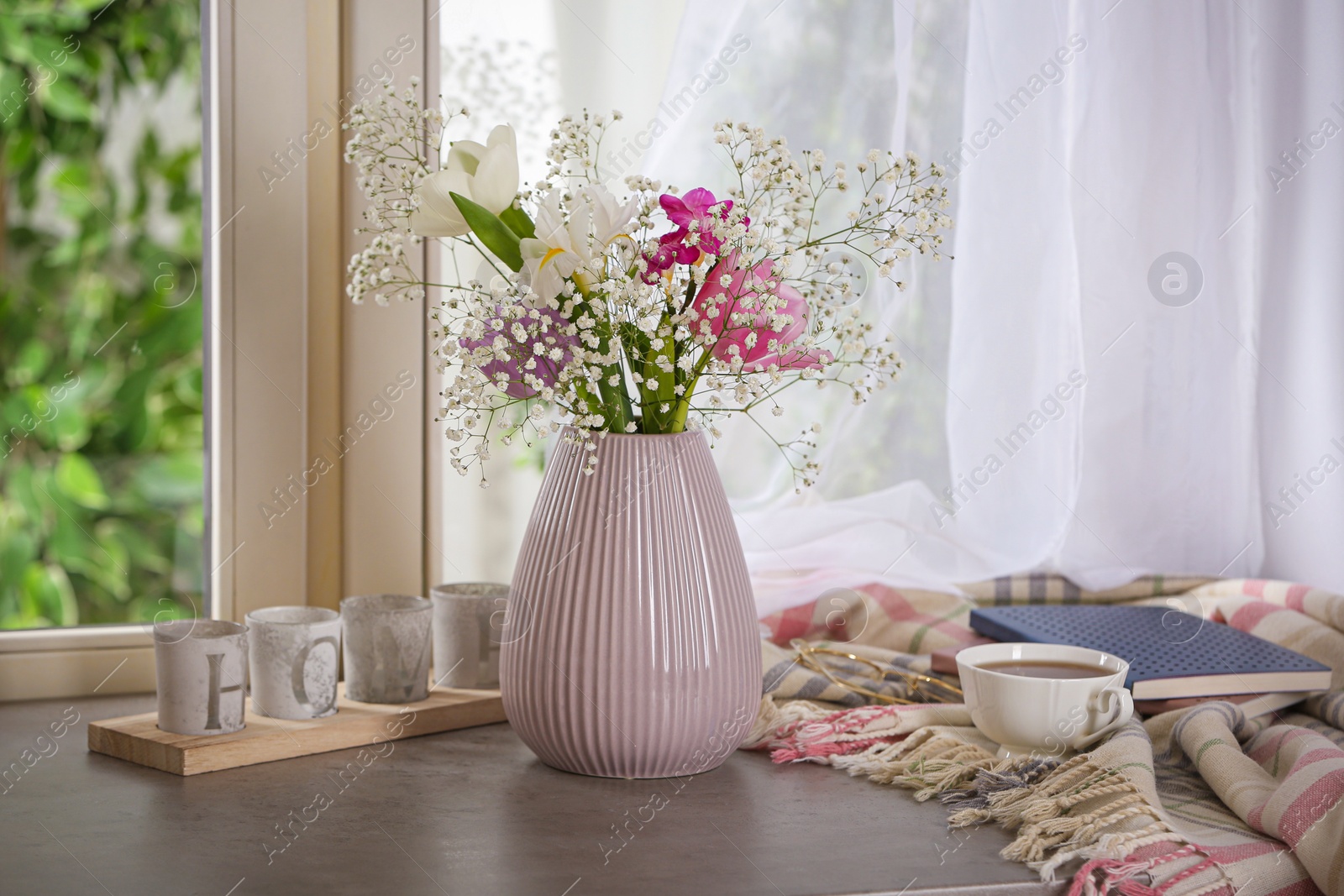 Photo of Beautiful fresh flowers on window sill indoors